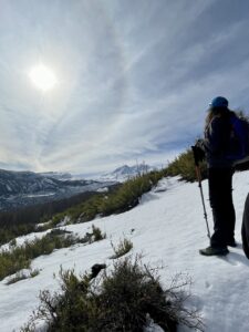 a person standing on a snowy hill